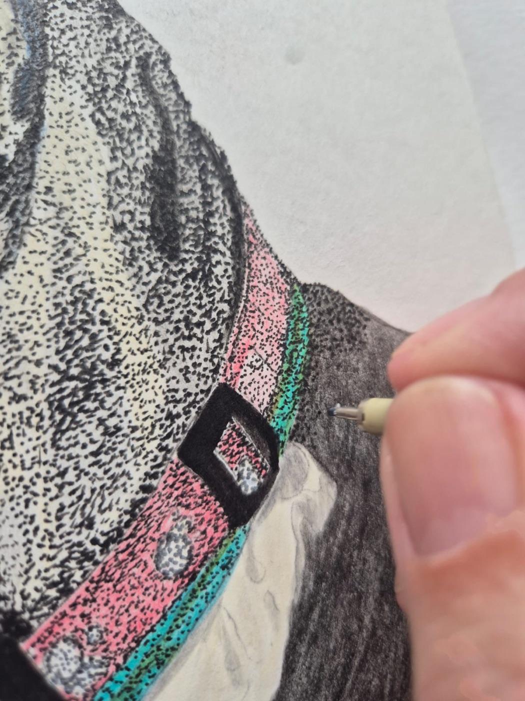 Close-up of the stippled collar: pink and turquoise ink dots beside the dotted black and white coat